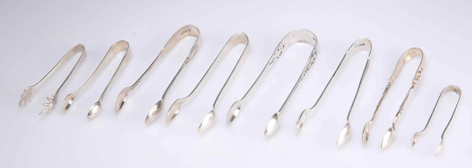 EIGHT PAIRS ASSORTED SILVER SUGAR NIPS, VICTORIAN AND LATER (1 of 2)