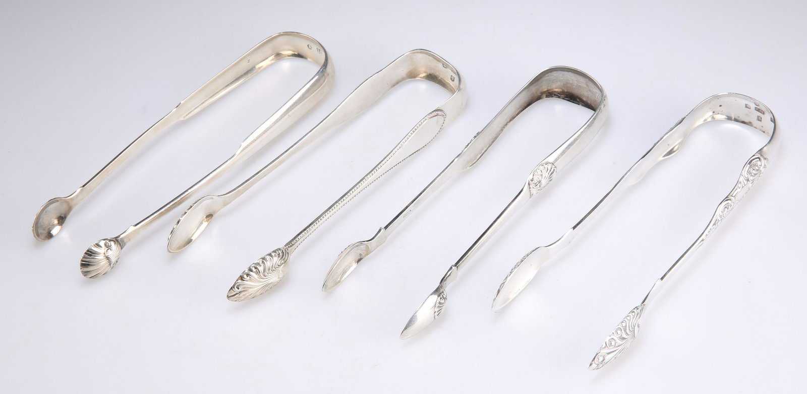 FOUR PAIRS OF GLASGOW SILVER SUGAR TONGS, GEORGE III AND LATER (1 of 2)