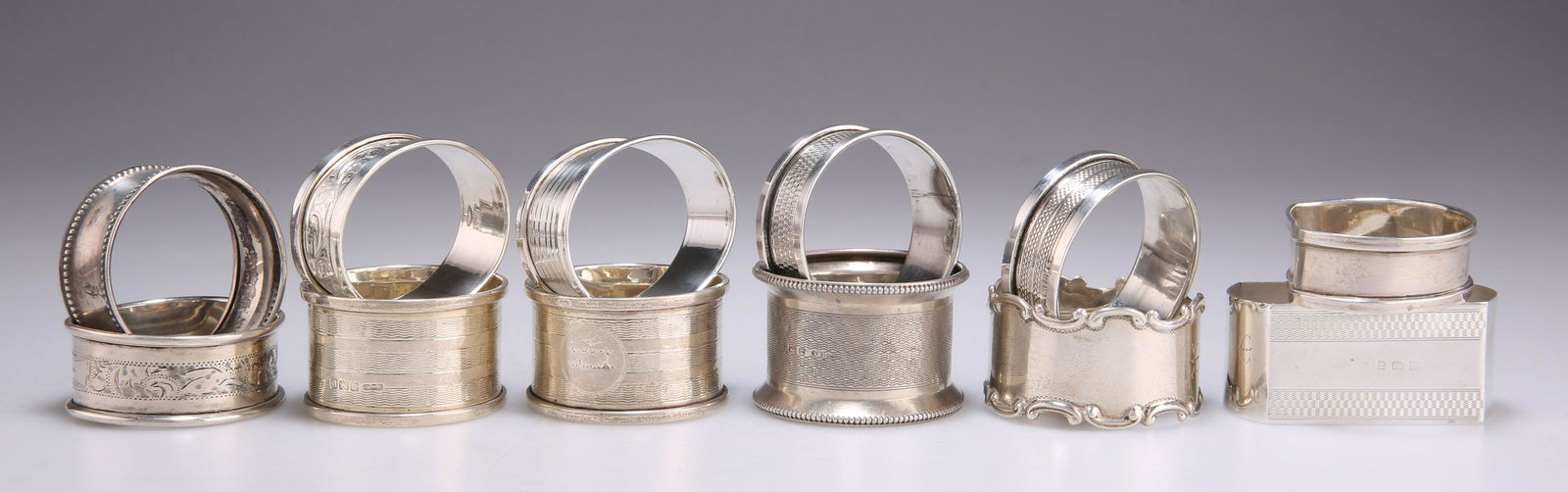 TWELVE ASSORTED SILVER NAPKIN RINGS, 20TH CENTURY (1 of 1)