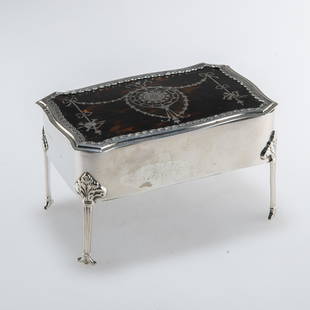 AN EDWARDIAN SILVER AND TORTOISESHELL JEWELLERY BOX: AN EDWARDIAN SILVER AND TORTOISESHELL JEWELLERY BOX William Comyns &amp; Sons, London 1909, of large size, the hinged rectangular cover pique work decorated with ribbon-tied swags and musical trophies