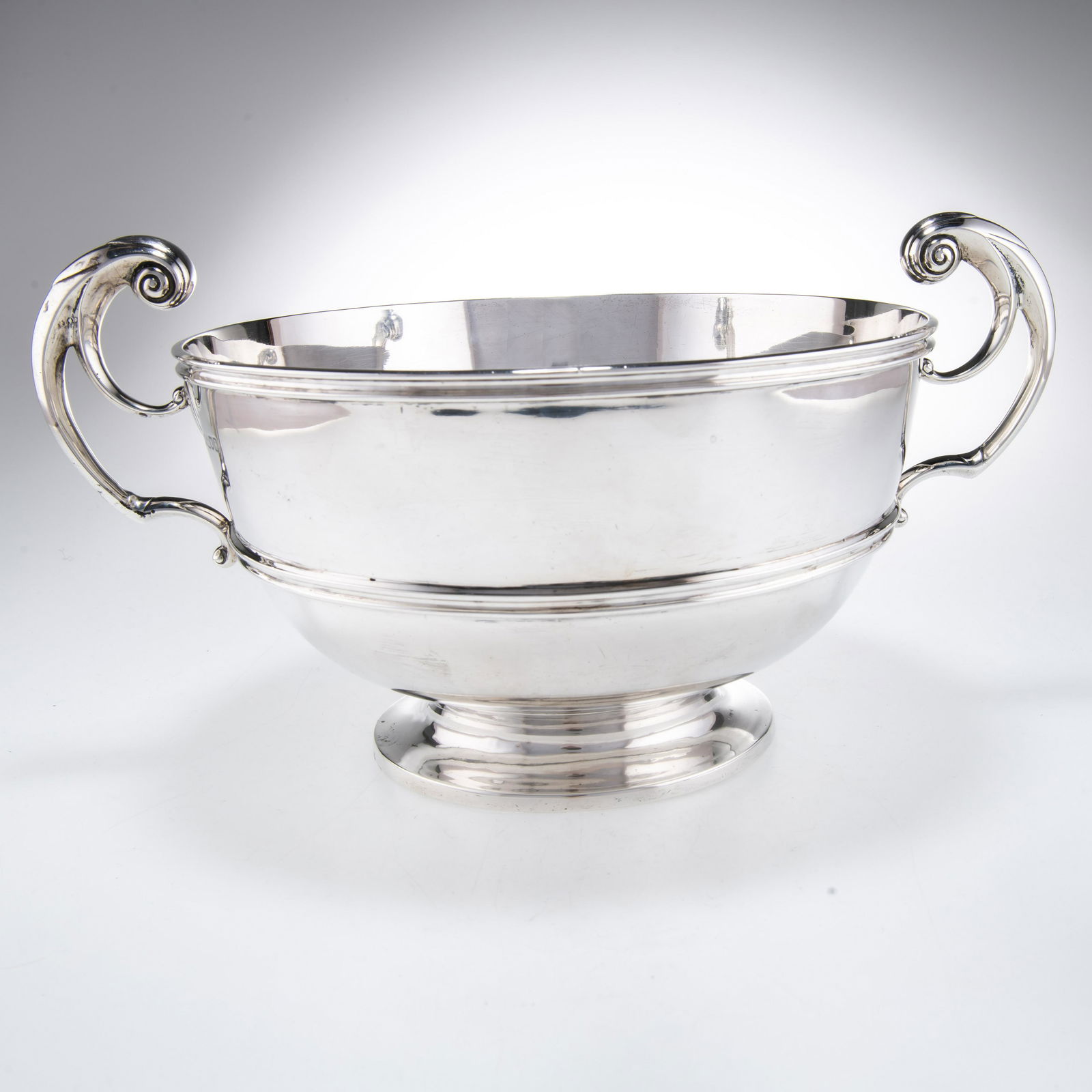 A LATE VICTORIAN SILVER TWIN-HANDLED BOWL: A LATE VICTORIAN SILVER TWIN-HANDLED BOWL by Charles Stuart Harris, London 1899, with reeded rim and girdle, bifurcated twin scroll handles, raised on a circular foot, engraved 'STREETER & CO LD /