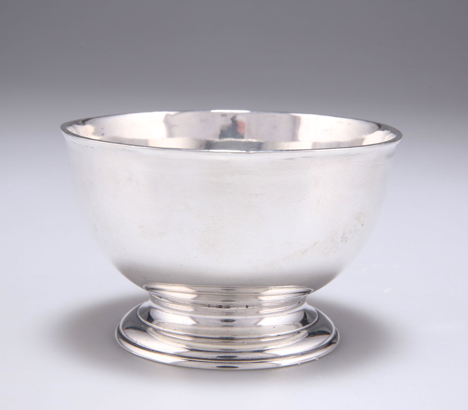 A GEORGE II SILVER SUGAR BOWL: A GEORGE II SILVER SUGAR BOWL by James Smith I, London 1732, plain circular form with a moulded domed foot. 9cm diameter, 4.6 troy ounces Early sugar bowls, like the small-size teapot, were of small