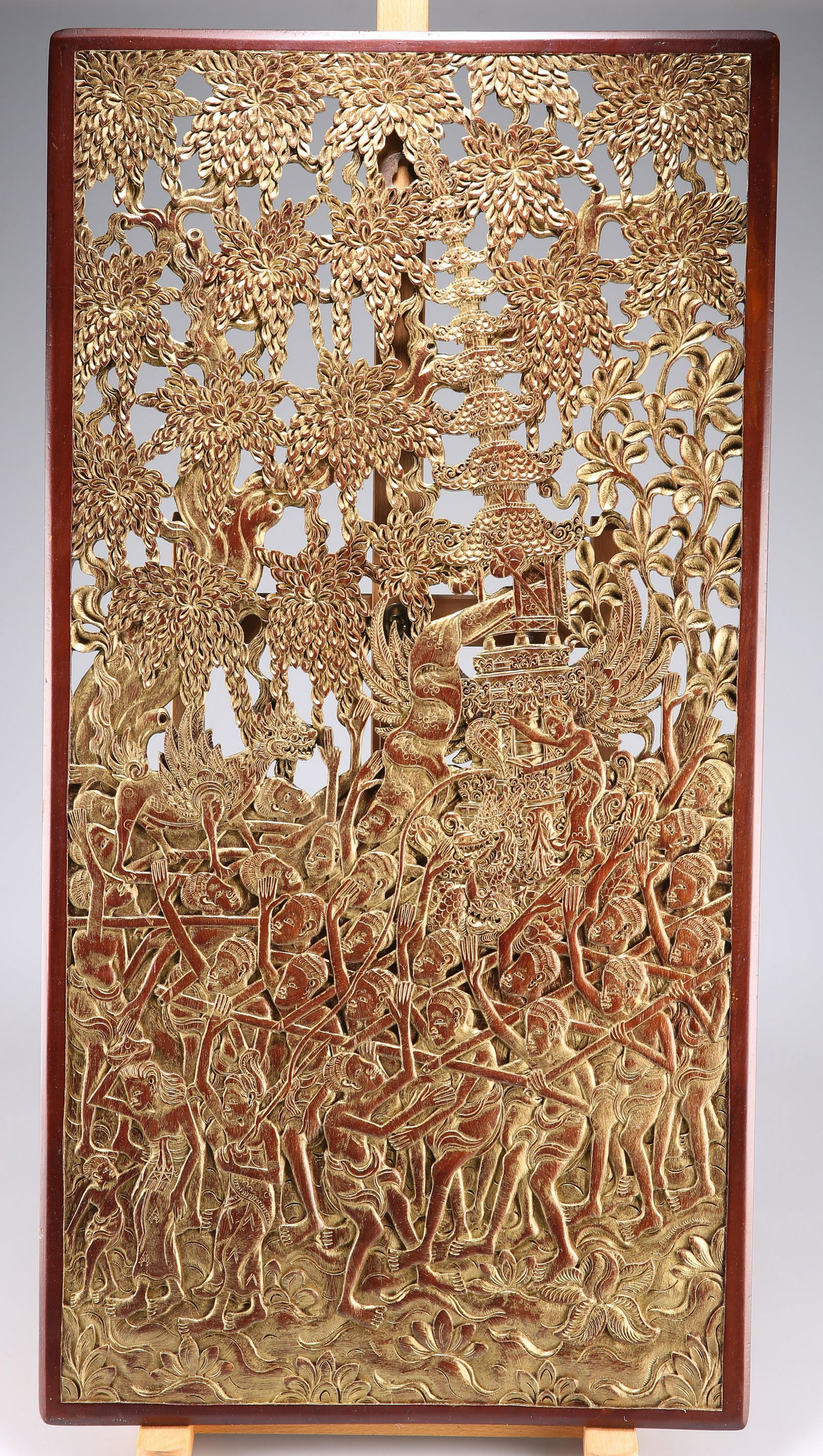 A SOUTHEAST ASIAN CARVED PANEL, POSSIBLY BALINESE: A SOUTHEAST ASIAN CARVED PANEL, POSSIBLY BALINESE teak, fretwork carved, with brass wall bracket affixed to the back. 76.5cm by 39.5cm