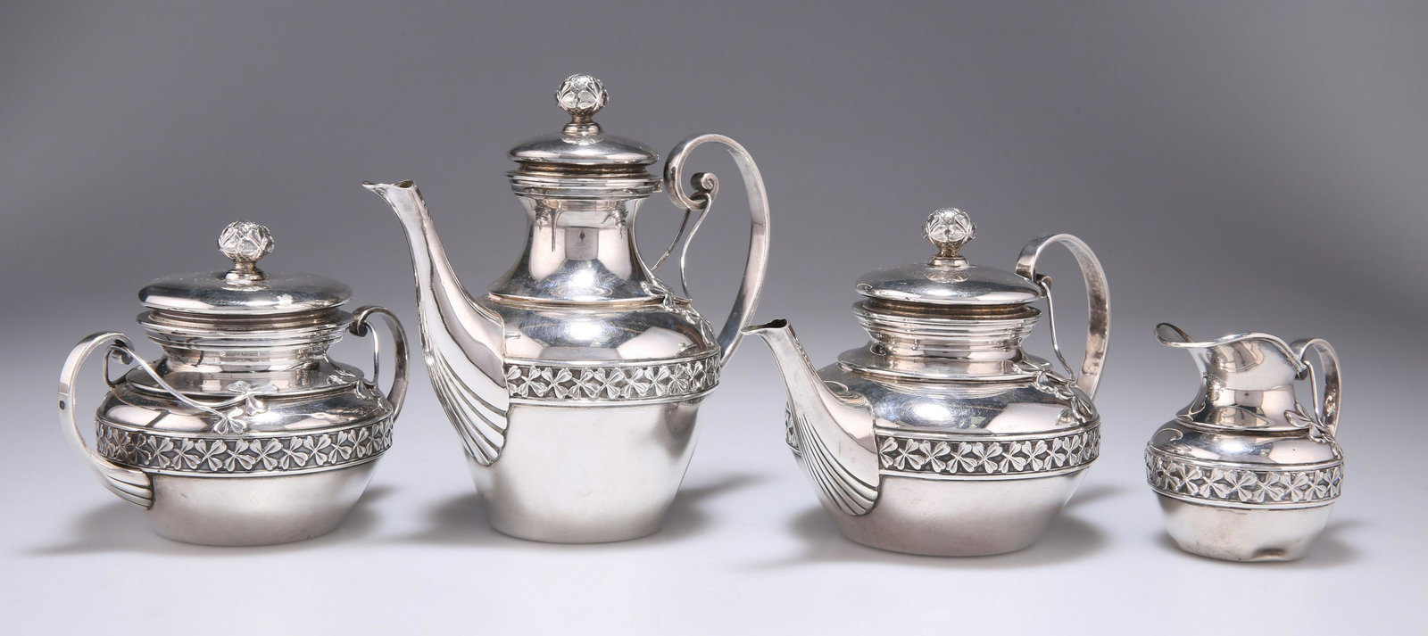 A FRENCH SILVER FOUR-PIECE BACHELOR'S TEA SERVICE: A FRENCH SILVER FOUR-PIECE BACHELOR'S TEA SERVICE by Alphonse Debain, Paris, late 19th/early 20th Century. (4) Tallest 13.5cm, 27.8 troy ounces gross