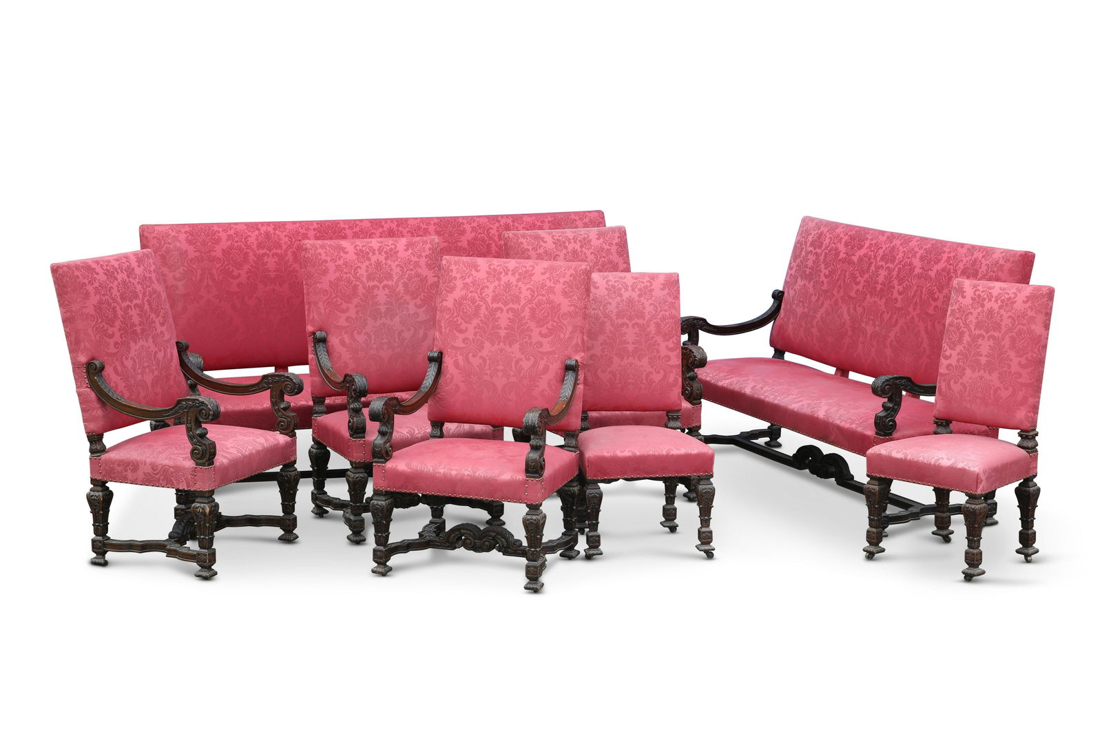A SUITE OF 19TH CENTURY CARVED AND STAINED BEECH SEATING: A SUITE OF 19TH CENTURY CARVED AND STAINED BEECH SEATING comprising two settees, four armchairs and two side chairs. (8) Largest settee 243cm long
