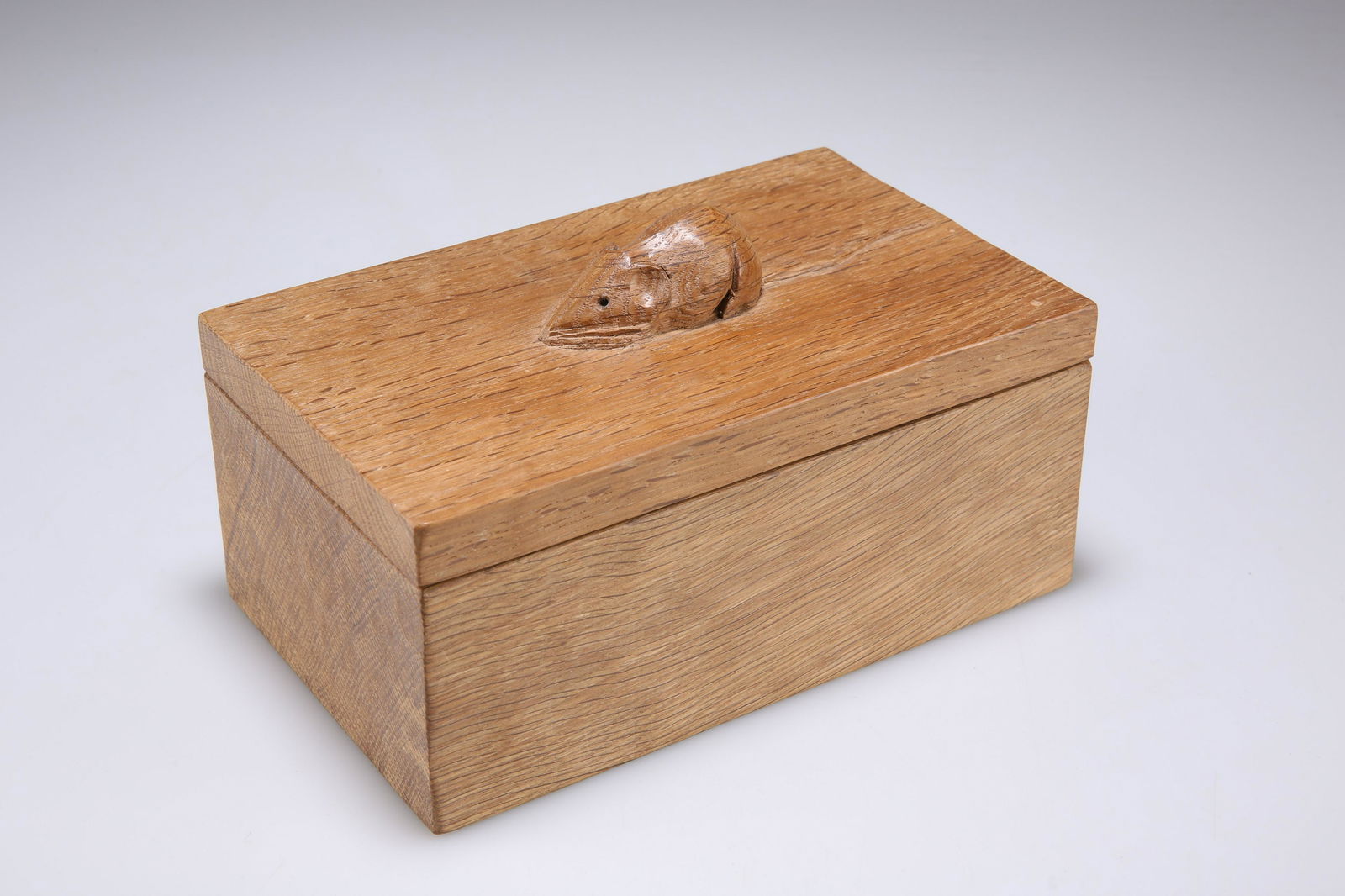 ROBERT THOMPSON OF KILBURN, A MOUSEMAN OAK TRINKET BOX AND COVER: ROBERT THOMPSON OF KILBURN, A MOUSEMAN OAK TRINKET BOX AND COVER rectangular, adzed, the lift-off cover with carved mouse signature. 18.5cm wide