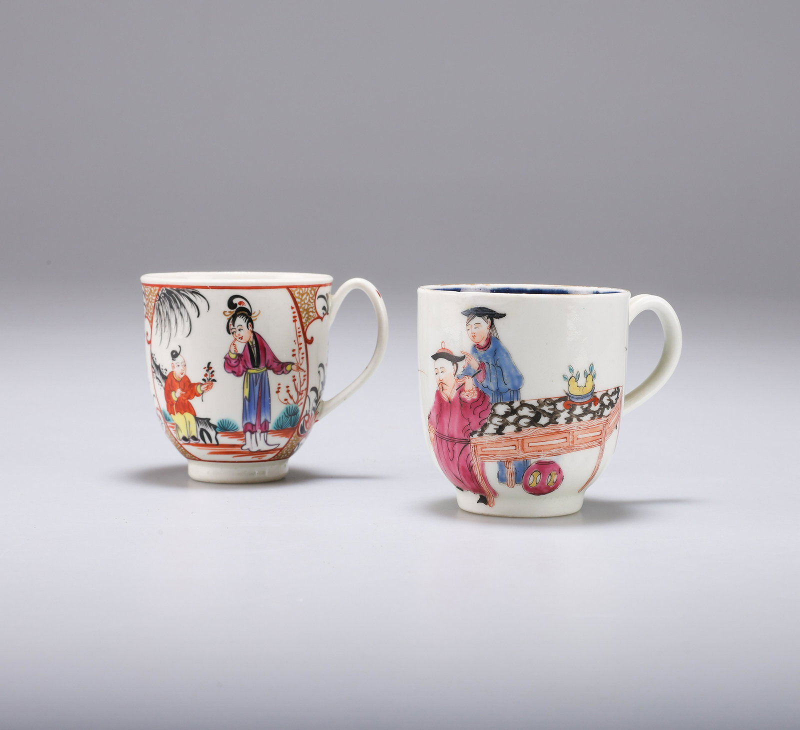 TWO WORCESTER POLYCHROME COFFEE CUPS: TWO WORCESTER POLYCHROME COFFEE CUPS comprising a 'Mandarin Wise Man and Butterfly' pattern coffee cup, 6cm high; together with another 'Mandarin' pattern coffee cup, 6.2cm high. (2)