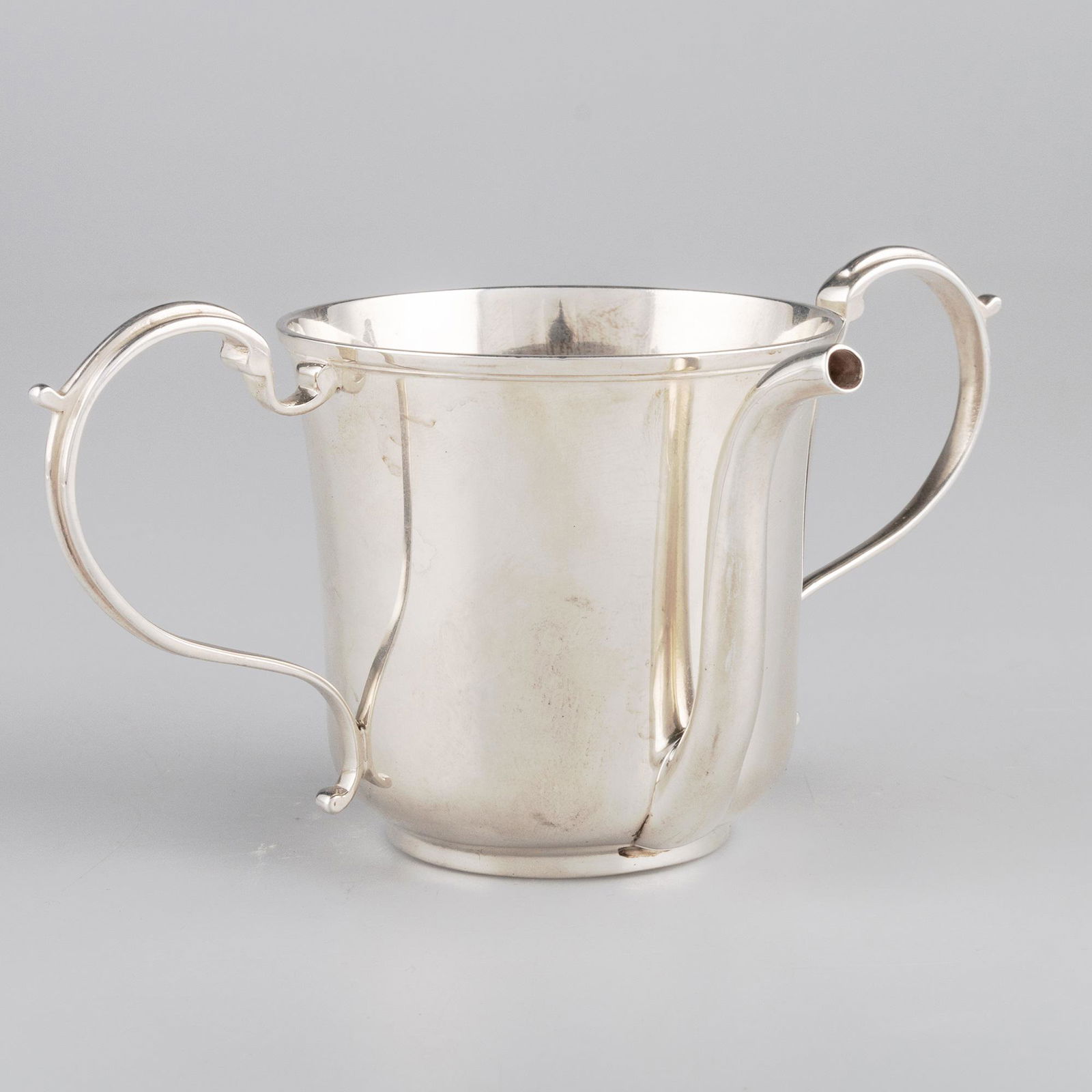 A GEORGE IV SILVER INVALID FEEDING BOAT: A GEORGE IV SILVER INVALID FEEDING BOAT by Thomas Johnson, London 1824, the cylindrical cup with twin S-scroll handles and tall spout. 8.5cm high, 5.5 troy ounces