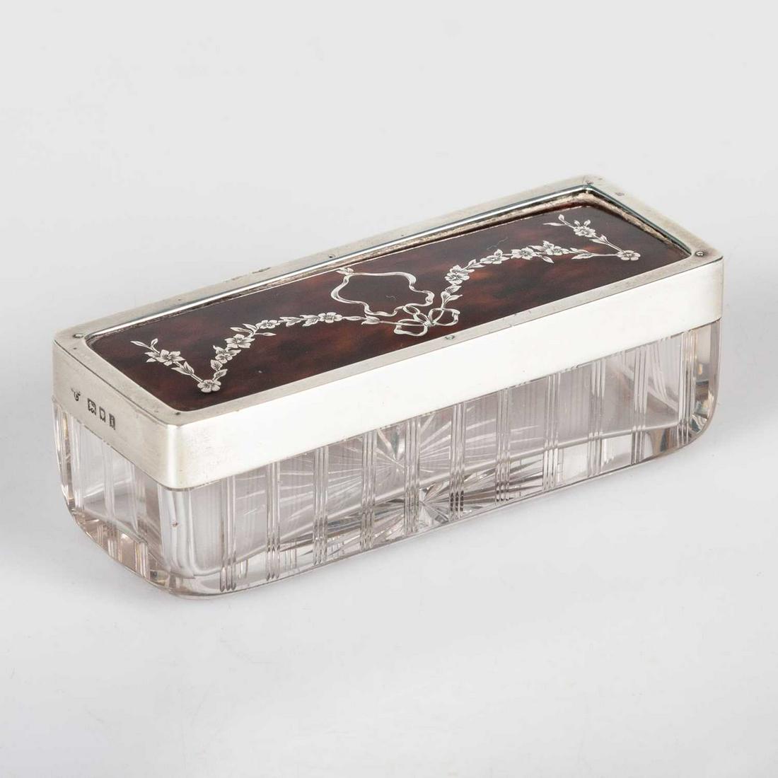 AN EDWARDIAN SILVER, TORTOISESHELL AND GLASS BOX: AN EDWARDIAN SILVER, TORTOISESHELL AND GLASS BOX by Charles and Richard Comyns, London 1904, the removable cover decorated with piqué work depicting floral ribbon-tied swags, cut glass with star-