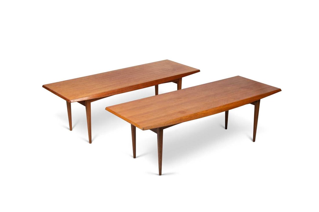 A PAIR OF GORDON RUSSELL TEAK COFFEE TABLES, BY TREVOR CHINN: A PAIR OF GORDON RUSSELL TEAK COFFEE TABLES, BY TREVOR CHINN each rectangular top raised on tapering legs, each labelled. (2) 41cm high, 121cm long, 46cm wide