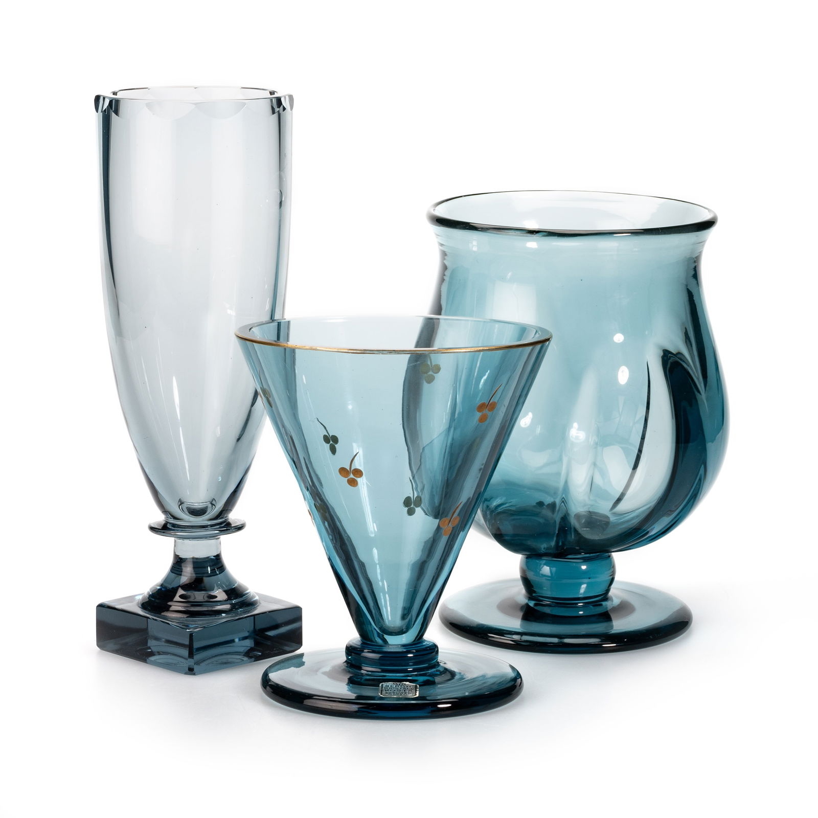 ELIS BERGH FOR KOSTA, THREE BLUE GLASS VASES, CIRCA 1930S: ELIS BERGH FOR KOSTA, THREE BLUE GLASS VASES, CIRCA 1930S including a tapering vase gilt-decorated with sprigs of foliage, etched marks, one with a paper label. (3) Tallest 25.5cm Each vase is in goo