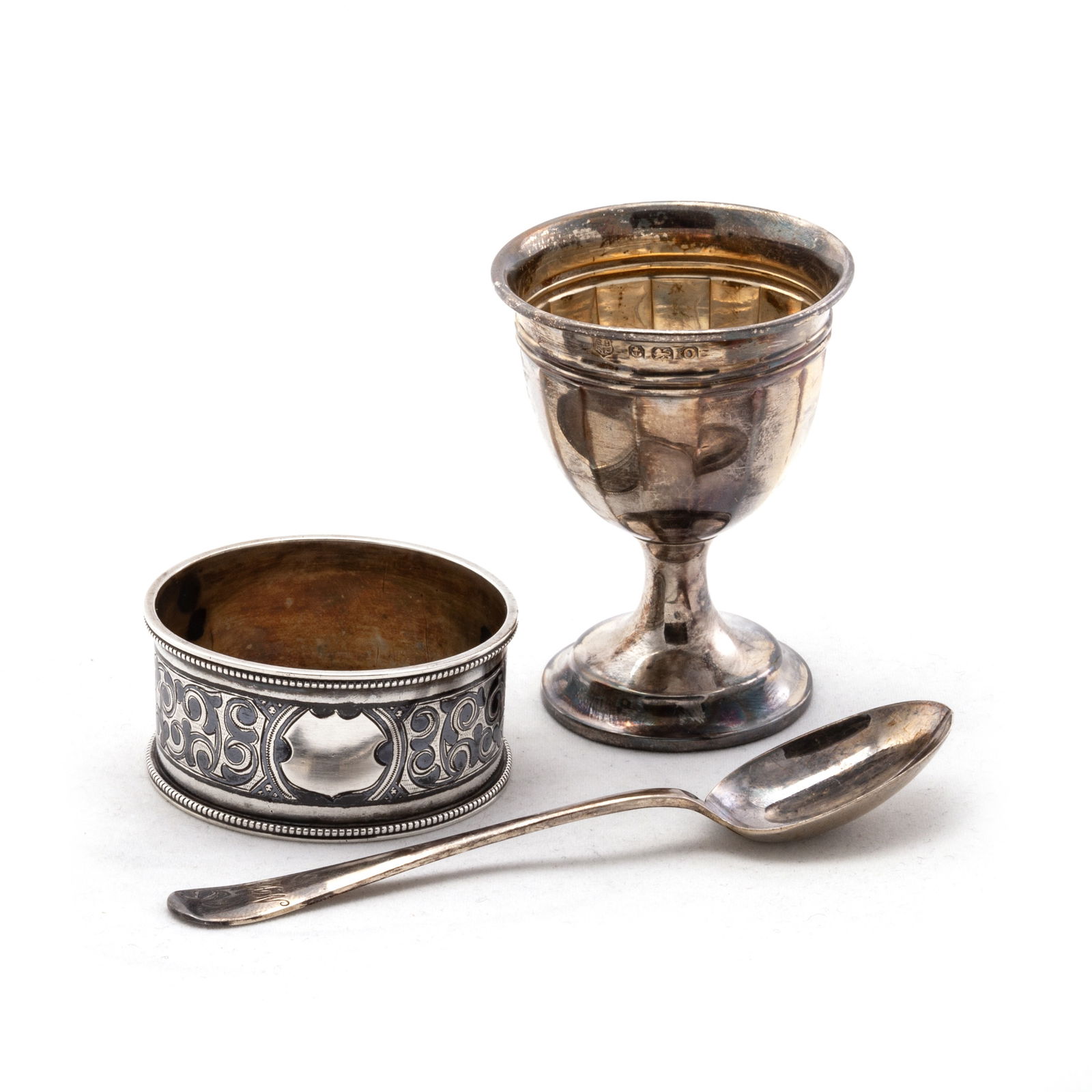 A RUSSIAN NIELLO AND SILVER NAPKIN RING, CASED; TOGETHER WITH A GEORGE VI SILVER EGG CUP AND SPOON: A RUSSIAN NIELLO AND SILVER NAPKIN RING, CASED; TOGETHER WITH A GEORGE VI SILVER EGG CUP AND SPOON by Barker Brothers Silver Ltd, Birmingham 1938, cased. (2 cases) Napkin ring 4.8cm diameter, 1.7 troy