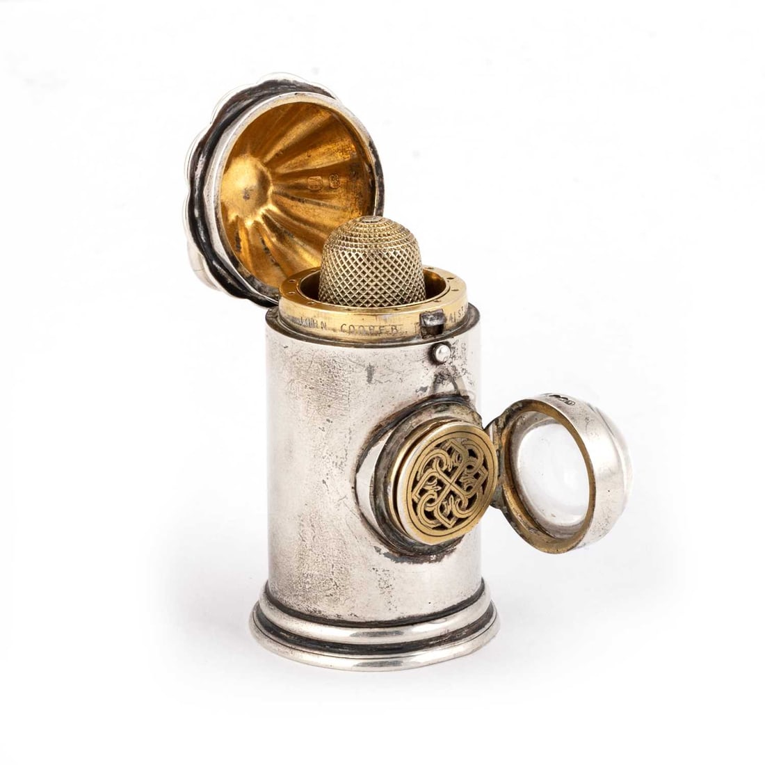 A VICTORIAN SILVER NOVELTY VINAIGRETTE AND SEWING NECESSAIRE: A VICTORIAN SILVER NOVELTY VINAIGRETTE AND SEWING NECESSAIRE by Henry William Dee, London 1871, in the form of a Police 'Bullseye' Lantern, the fluted hinged cover opens with a push-button to reveal t
