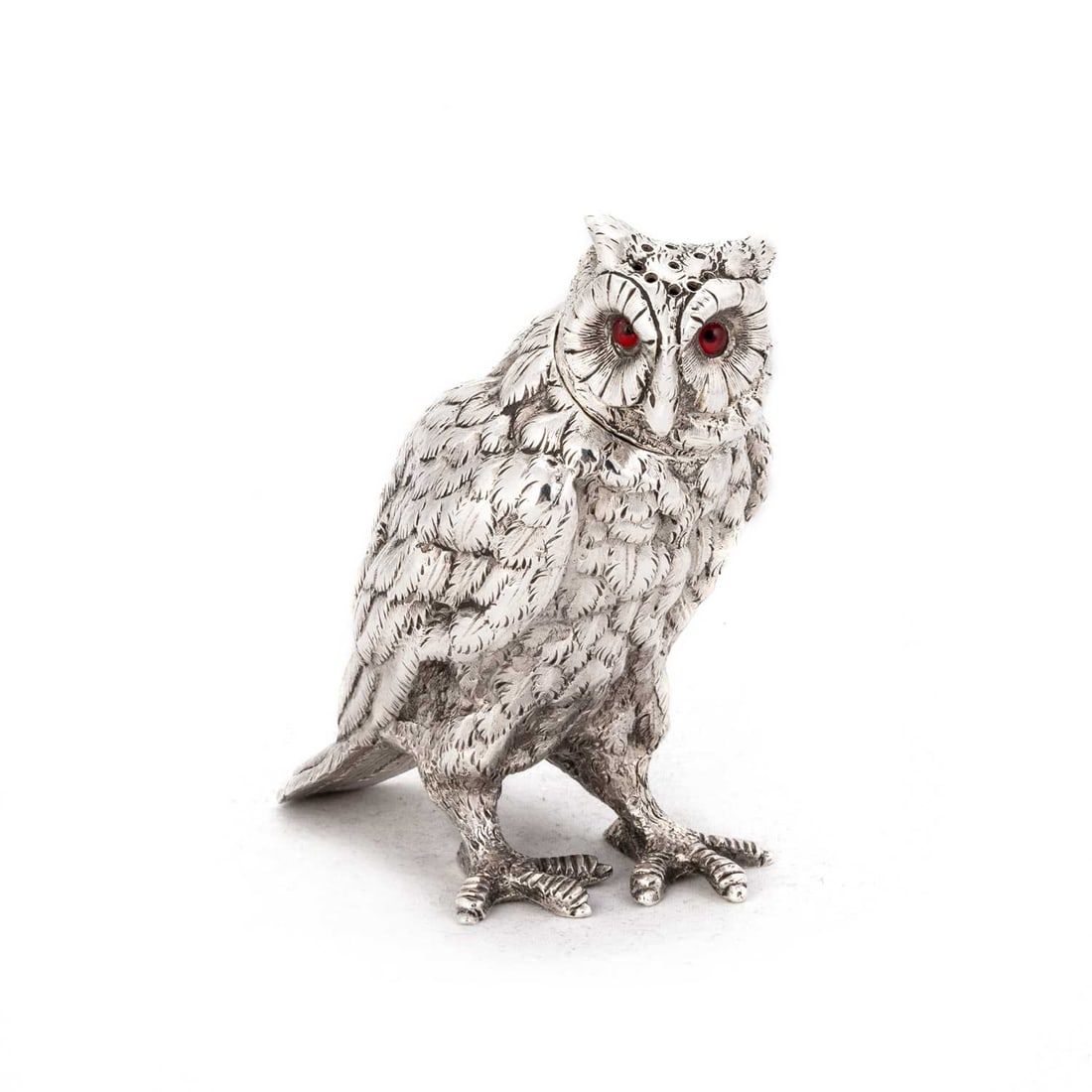 A VICTORIAN CAST SILVER NOVELTY PEPPER POT: A VICTORIAN CAST SILVER NOVELTY PEPPER POT by Thomas Johnson II, London 1882, in the form of an owl, with inset eyes. 8cm high, 4.7 troy ounces