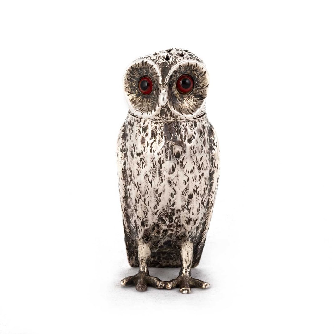 A VICTORIAN SILVER NOVELTY PEPPER POT: A VICTORIAN SILVER NOVELTY PEPPER POT by Charles Thomas Fox & George Fox, London 1853, in the form of an owl, with inset eyes. 8cm high, 2 troy ounces