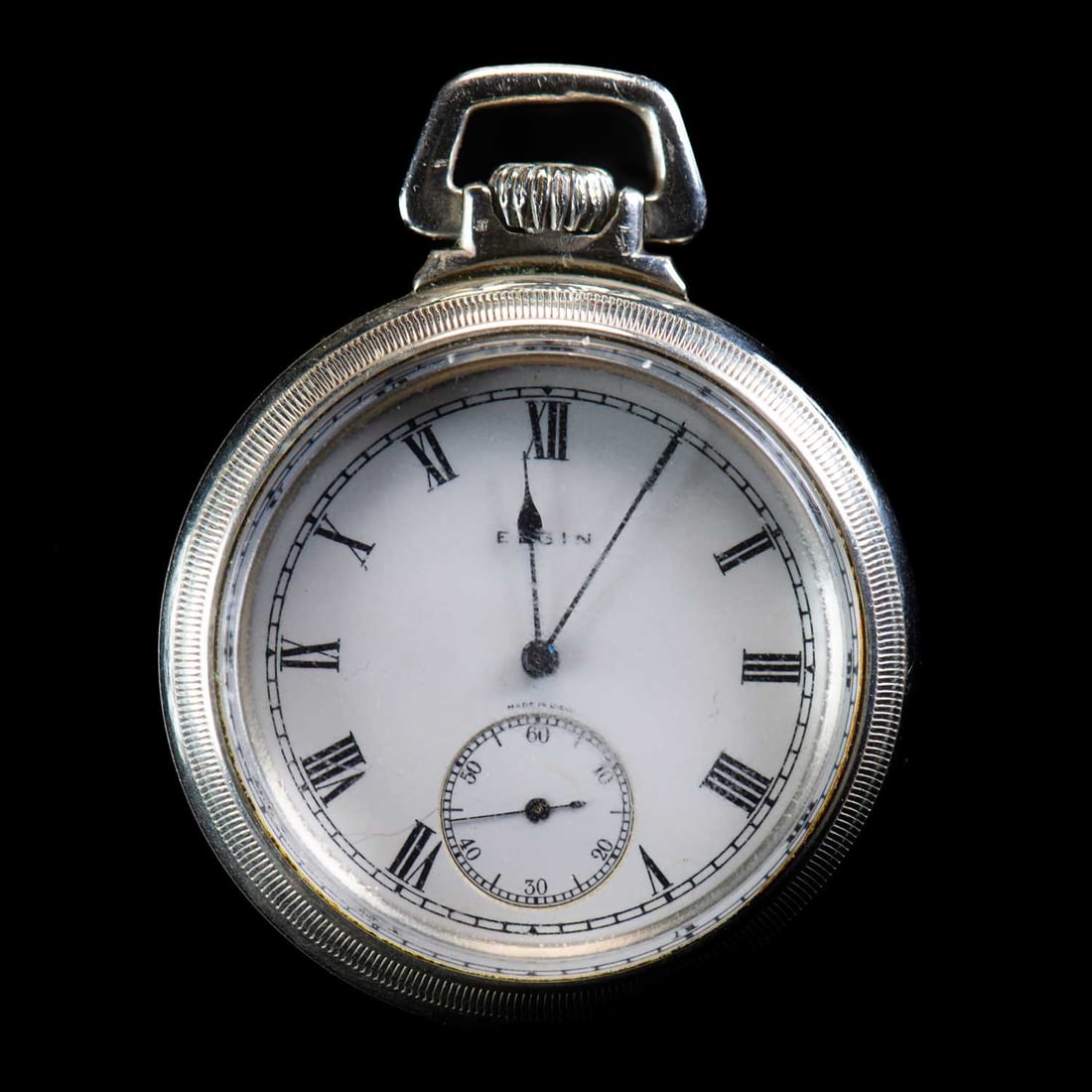 AN ELGIN OPEN FACE POCKET WATCH: AN ELGIN OPEN FACE POCKET WATCH circular white enamel dial signed Elgin Made in USA, with Roman index and outer minute track, sub seconds dial at 6 o'clock position, blued steel hands, plain case with