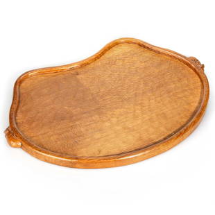 ROBERT THOMPSON OF KILBURN, A MOUSEMAN OAK TEA TRAY, CIRCA 1970: ROBERT THOMPSON OF KILBURN, A MOUSEMAN OAK TEA TRAY, CIRCA 1970 kidney-shaped, with carved mouse trademark handles, adzed. 48cm wide