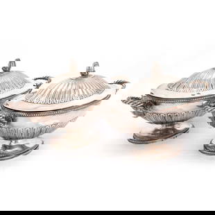 A PAIR OF GEORGE III SILVER SAUCE TUREENS: A PAIR OF GEORGE III SILVER SAUCE TUREENS by Andrew Fogelberg & Stephen Gilbert, London 1780, oval, the covers with fluted domed centres surmounted by a compressed bun finial, the bowls with a ram