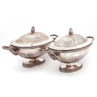 A PAIR OF GEORGE III SILVER SAUCE TUREENS: A PAIR OF GEORGE III SILVER SAUCE TUREENS by Andrew Fogelberg & Stephen Gilbert, London 1780, oval, the covers with fluted domed centres surmounted by a compressed bun finial, the bowls with a ram