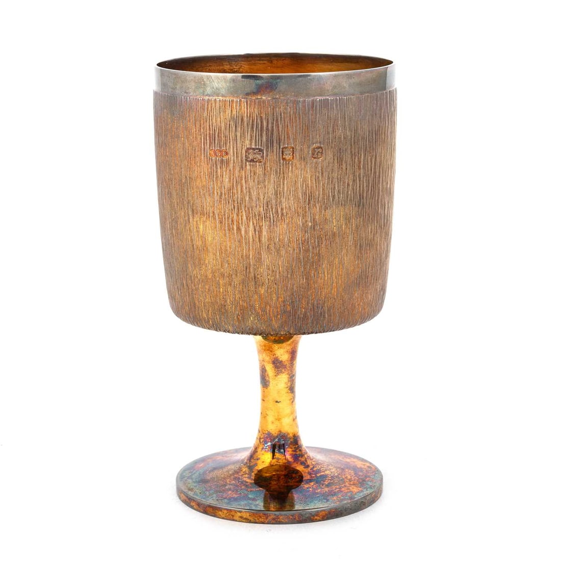 GERALD BENNEY: AN ELIZABETH II SILVER-GILT GOBLET: GERALD BENNEY: AN ELIZABETH II SILVER-GILT GOBLET London 1972, the textured bowl with a plain rim above a plain stem, raised on a circular foot, engraved to the underside of the base 1953-1973, cased.