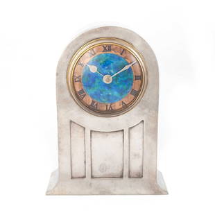 DAVID VEASEY FOR LIBERTY & CO, A TUDRIC PEWTER AND ENAMEL MANTEL CLOCK: DAVID VEASEY FOR LIBERTY & CO, A TUDRIC PEWTER AND ENAMEL MANTEL CLOCK turquoise enamel dial enclosed within a spot-hammered arched case with three-panel front, no. 01269, stamped ENGLISH PEWTER M