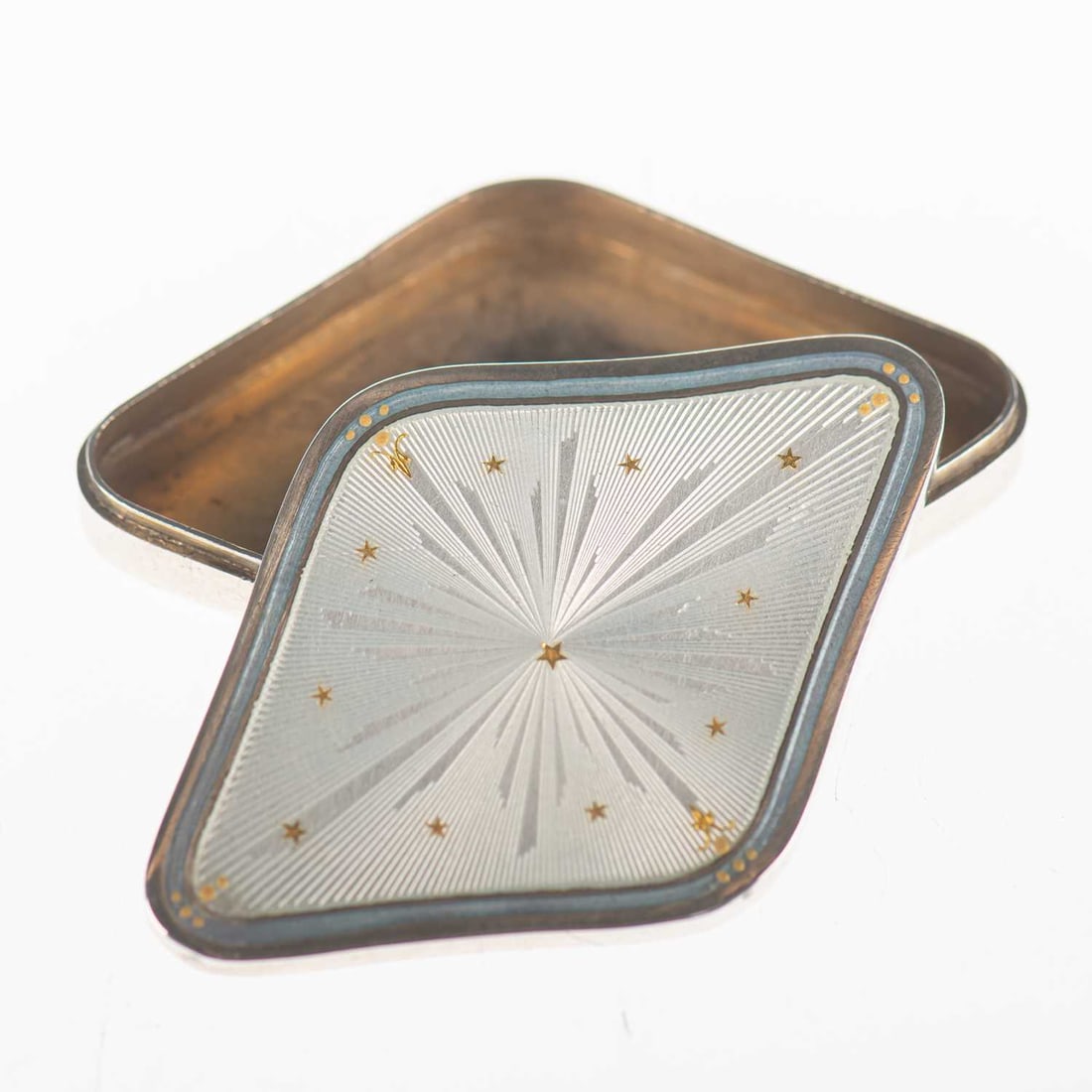 A CONTINENTAL SILVER AND ENAMEL PILL BOX: A CONTINENTAL SILVER AND ENAMEL PILL BOX early 20th Century, lozenge-shaped, the pull-off cover decorated with pale blue enamel and with gilt star highlights, 900 grade, inscribed MARY - 1 MAGGIO 1918