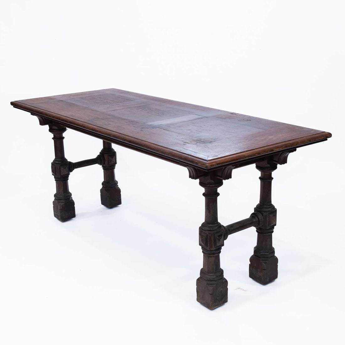 A MAHOGANY LIBRARY TABLE, CIRCA 1870, LABEL OF MARSH, JONES & CRIBB: A MAHOGANY LIBRARY TABLE, CIRCA 1870, LABEL OF MARSH, JONES & CRIBB the rectangular parquetry top raised above a plain frieze on turned, block and chamfered legs joined by stretchers. 77cm high, 182.5