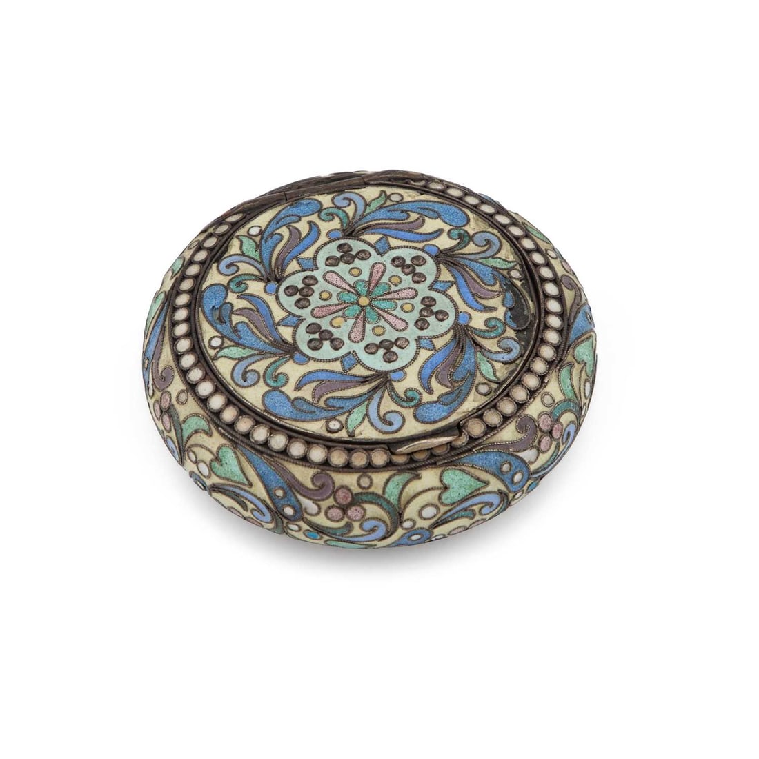 A RUSSIAN SILVER AND CLOISONNÉ ENAMEL SNUFF BOX: A RUSSIAN SILVER AND CLOISONNÉ ENAMEL SNUFF BOX circular with rounded sides, the flush cover with a recessed hinge, decorated in pastel enamels with scrolling foliage and florets, the interior gilded