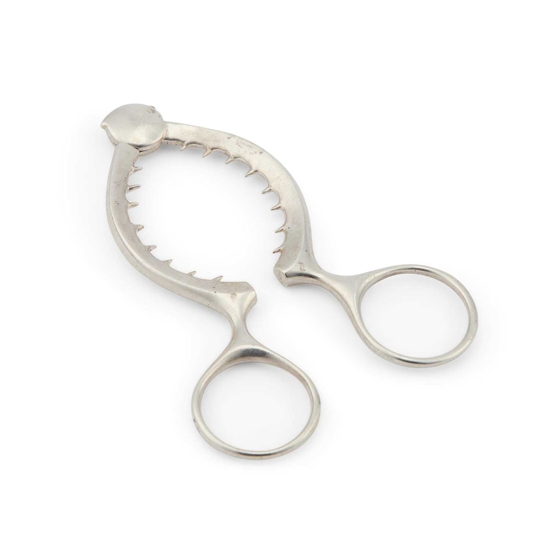 AN ELIZABETH II SILVER EGG TOPPER: AN ELIZABETH II SILVER EGG TOPPER by Brian Leslie Fuller, London 1986, of scissor form with ring handles. 10cm long, 1.4 troy ounces The marks are clear. The hinge works well. In generally very good