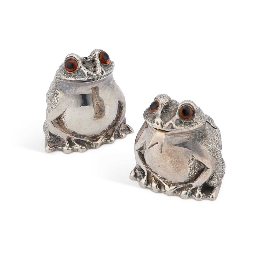 A PAIR OF ELIZABETH II SILVER NOVELTY PEPPER AND MUSTARD POTS: A PAIR OF ELIZABETH II SILVER NOVELTY PEPPER AND MUSTARD POTS by Richard Comyns, London 1971 and 1976, each modelled as a frog in a seated pose, with textured decoration and glass eyes, the mustard p