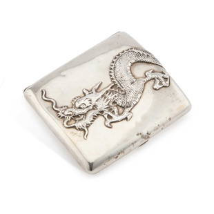 A CHINESE SILVER CIGARETTE CASE: A CHINESE SILVER CIGARETTE CASE retailed by Sing Fat, Canton, early 20th Century, oblong, shaped for the pocket, applied with a dragon wrapped around the front and back, signed to the interior. 8.2cm