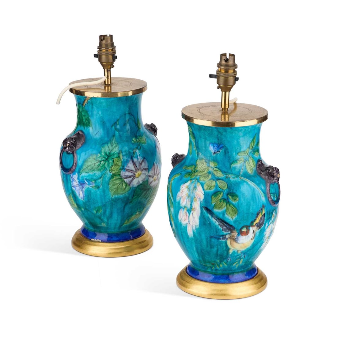 A PAIR OF AESTHETIC POTTERY TABLE LAMPS, IN THE MANNER OF THEODORE DECK: A PAIR OF AESTHETIC POTTERY TABLE LAMPS, IN THE MANNER OF THEODORE DECK each vase with moulded zoomorphic handles and painted with a bird flying amidst flowering foliage. (2) 37cm high overall Late 1