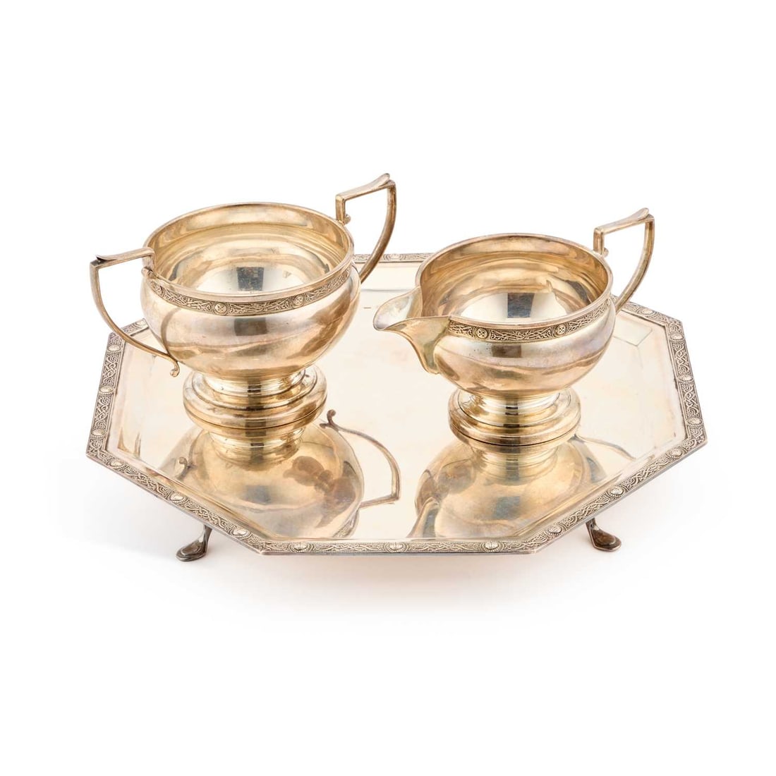 A GEORGE VI SILVER SALVER: A GEORGE VI SILVER SALVER by Roberts & Dore Ltd, Birmingham 1937, octagonal form, Celtic pattern; together with a cream jug and two-handled sugar bowl by the same maker, Birmingham 1935, Celtic pa