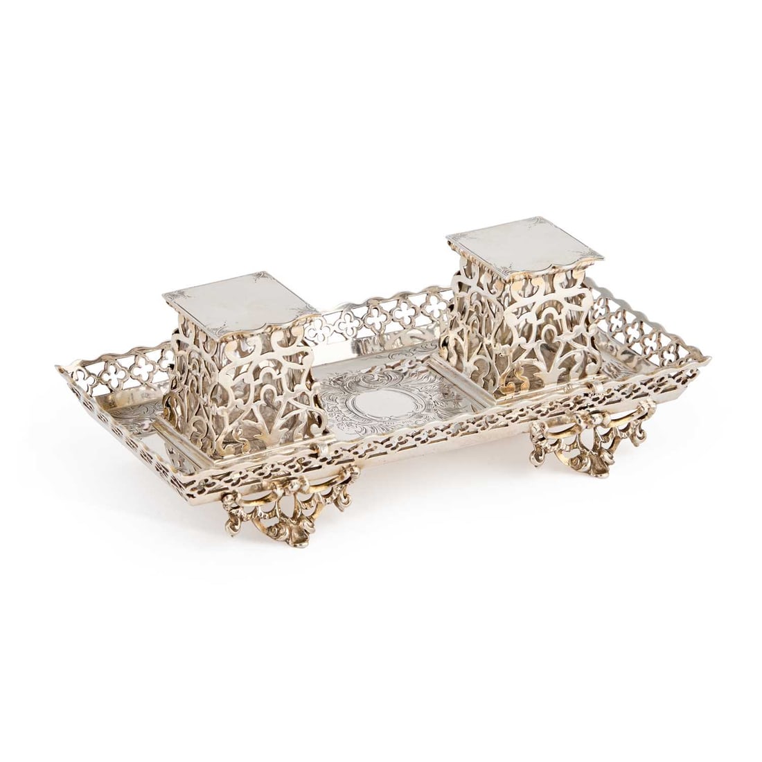 A VICTORIAN SILVER INKSTAND: A VICTORIAN SILVER INKSTAND by George Fox, London 1866, rectangular with a pierced quatrefoil gallery, the base engraved with rocaille and housing a pair of glass inkwells within pierced tapering squa