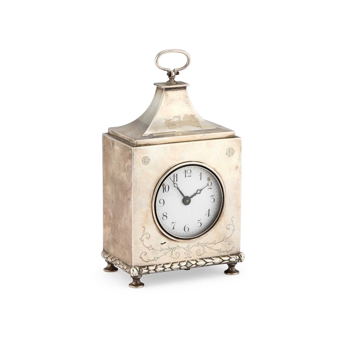 A GEORGE V SILVER MANTEL CLOCK: A GEORGE V SILVER MANTEL CLOCK by Charles & Richard Comyns, London 1916, the rectangular case with a domed top and carrying handle, the front engraved with scrolling foliage above an applied leaf