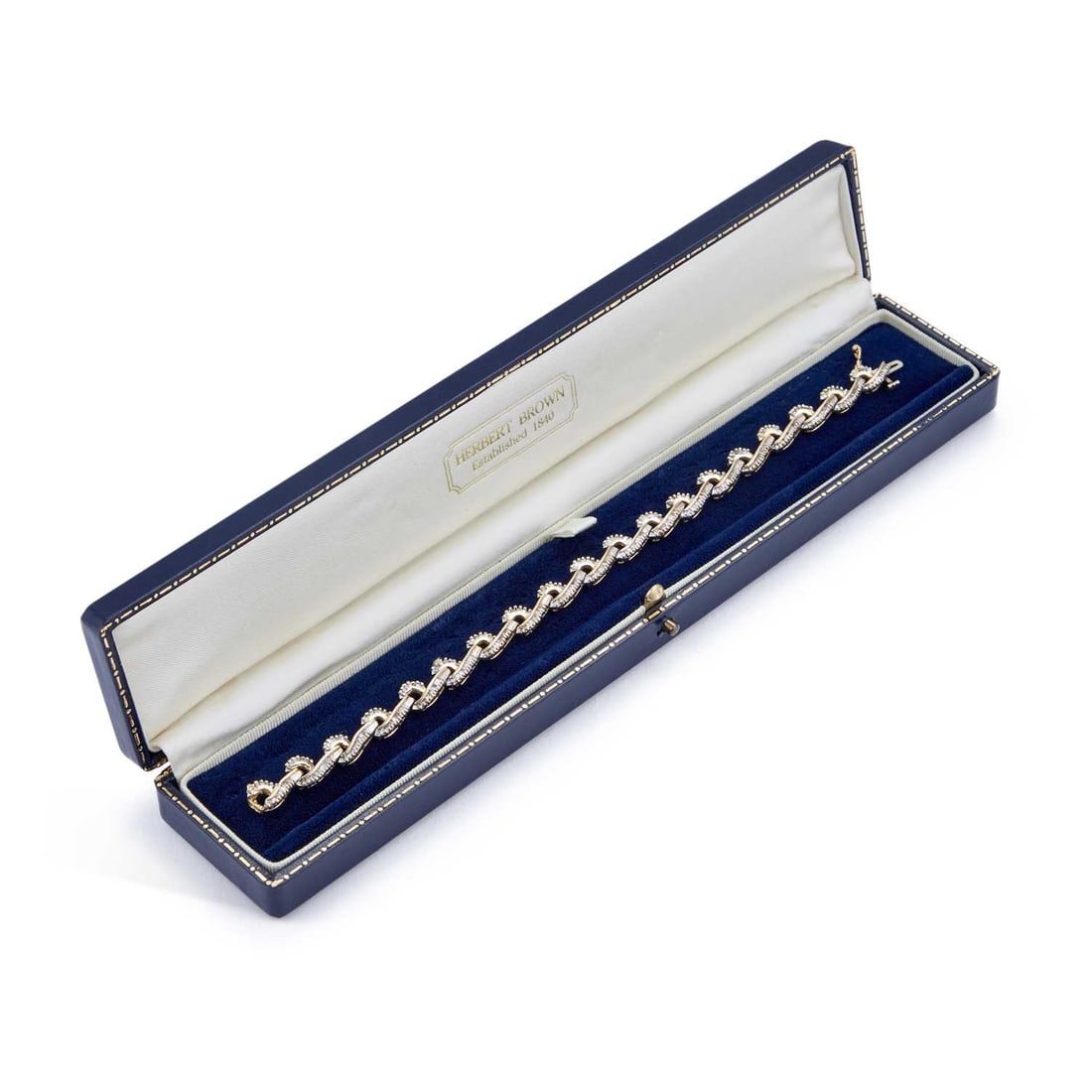 A DIAMOND BRACELET: A DIAMOND BRACELET articulated scroll links set throughout with baguette-cut diamonds, unmarked. Estimated total diamond weight 3.20 carat, length 19cm, 15.3 grams Good condition. Estimated diamond co