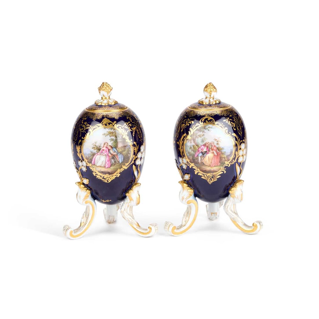 A NEAR PAIR OF MEISSEN EGG-SHAPED VASES AND COVERS, CIRCA 1880: A NEAR PAIR OF MEISSEN EGG-SHAPED VASES AND COVERS, CIRCA 1880 each on three rocaille feet, the ovoid body with a cobalt blue ground and rich gilt decoration, featuring three gold-framed cartouches fi