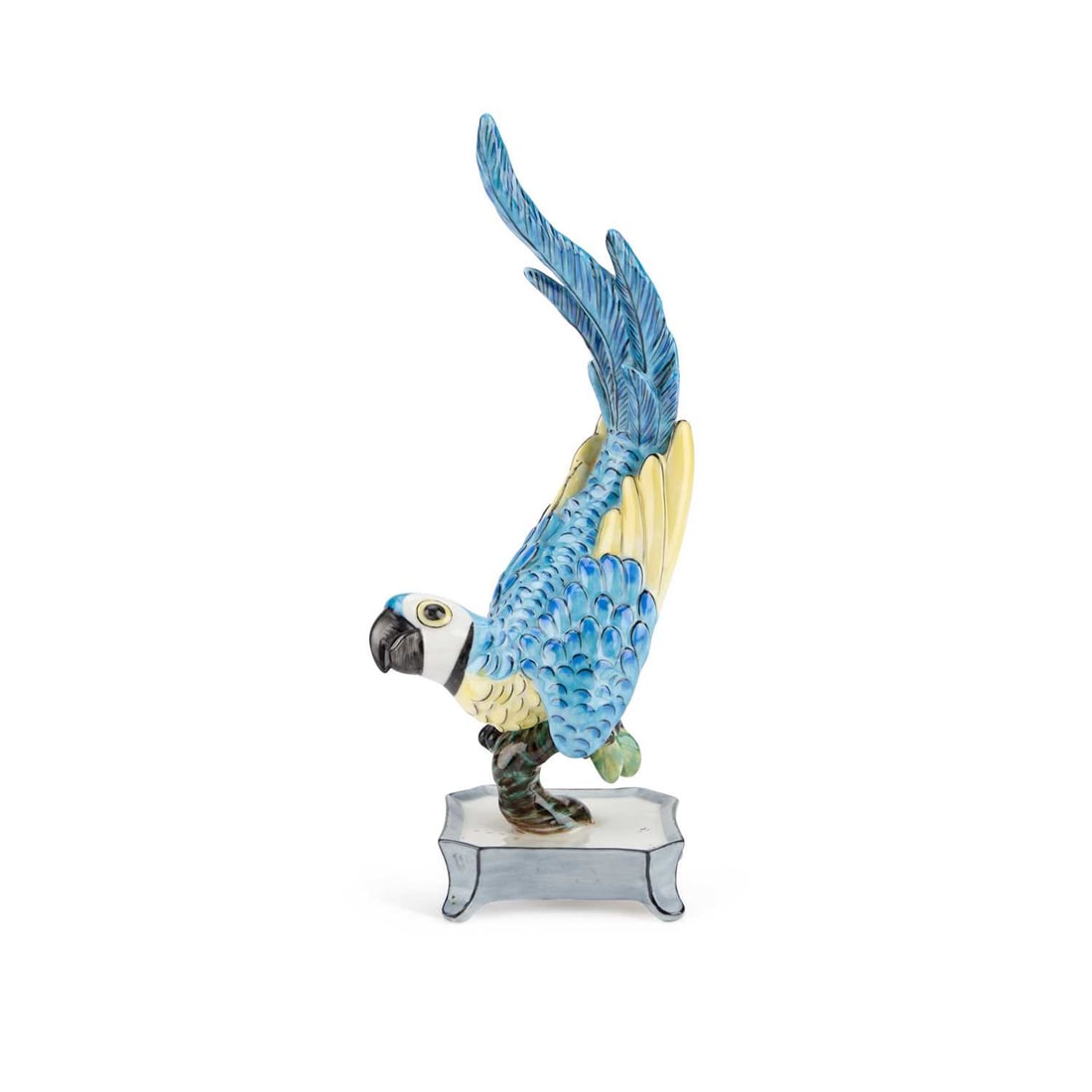 A NYMPHENBURG PORCELAIN MODEL OF A PARROT: A NYMPHENBURG PORCELAIN MODEL OF A PARROT modelled perched on a leafy stump above a cut-cornered base with splayed feet, no. 719, green printed mark. 20.5cm high