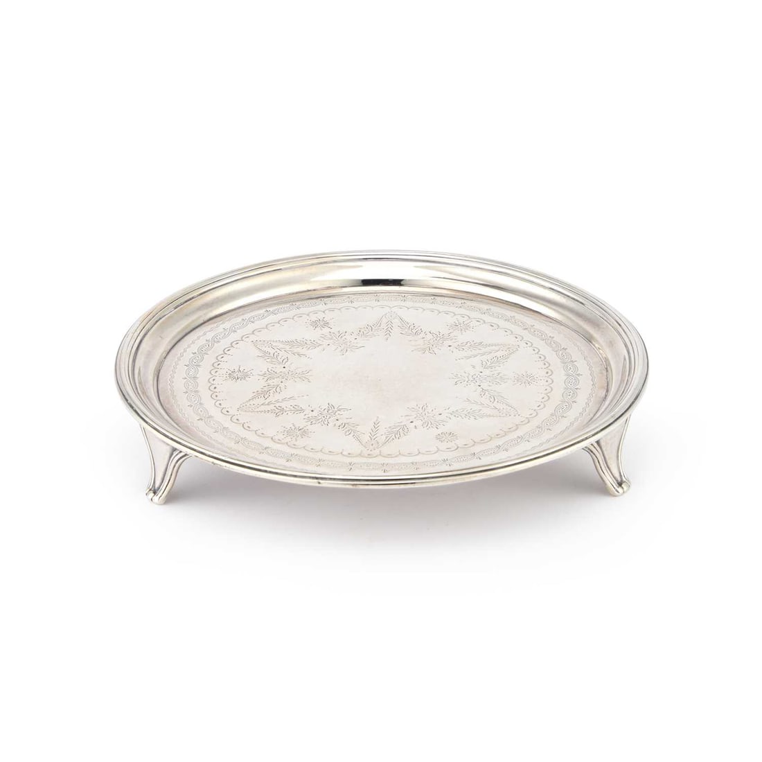 A GEORGE III SILVER WAITER: A GEORGE III SILVER WAITER by Thomas Hayter, London 1807, circular, with a reeded edge and three tapering feet, the centre bright-cut engraved. 18cm diameter, 9.7 troy ounces The marks are clear and