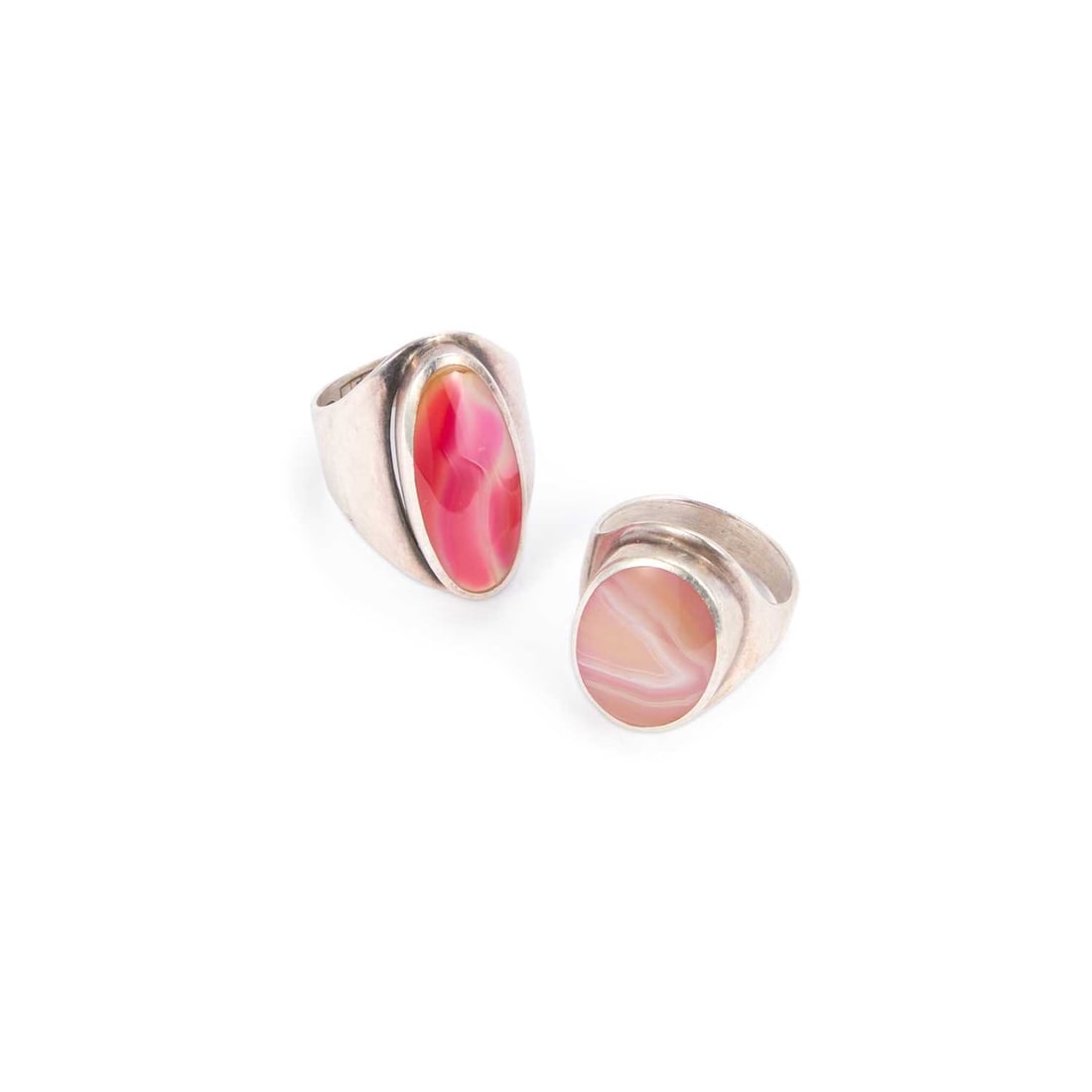 DAVID SCOTT WALKER: TWO SILVER RINGS: DAVID SCOTT WALKER: TWO SILVER RINGS one set with an oval pink agate, the other with coloured glass, both hallmarked, Sheffield 2003 and 2004. (2) Ring size Q1/2 and R1/2, 15 grams gross Good conditi