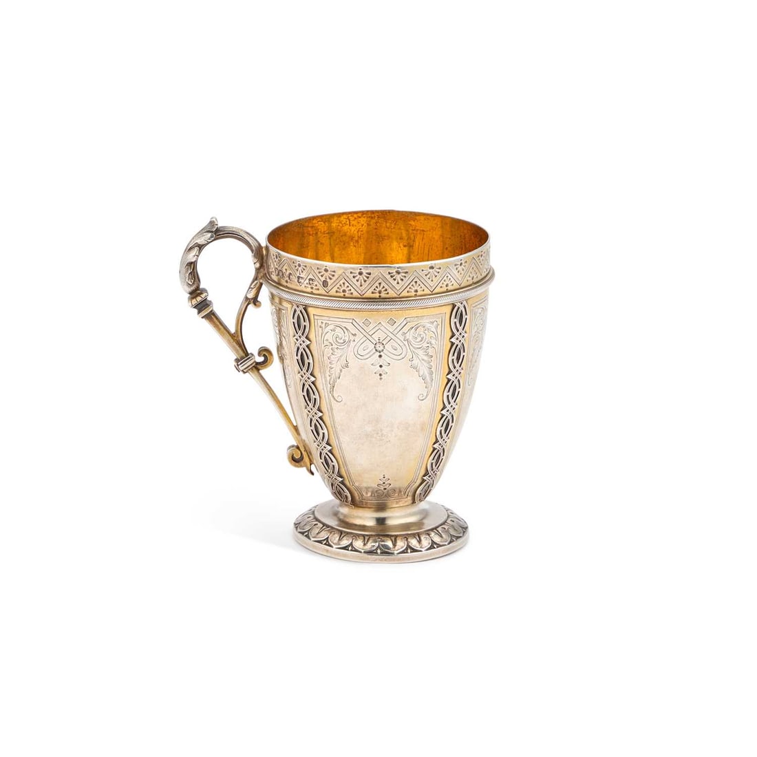 A VICTORIAN SILVER-GILT MUG: A VICTORIAN SILVER-GILT MUG by Frederick Elkington, Birmingham 1869, featuring a leaf-capped scroll handle, the body engraved and applied with interlaced bands, raised on a circular foot with a leaf-