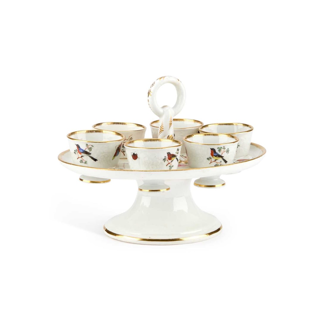 A COALPORT EGG CRUET CIRCA 1830: A COALPORT EGG CRUET CIRCA 1830 of oval form, the dished tray with a central handle surrounded by six egg cups, each painted with birds and floral sprigs, raised on an oval foot, heightened with gildi