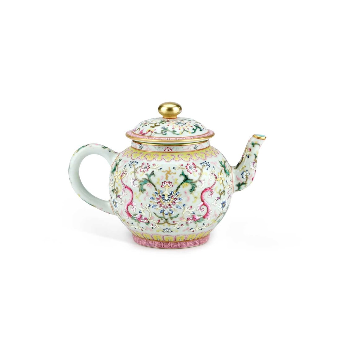 A CHINESE FAMILLE ROSE TEAPOT: A CHINESE FAMILLE ROSE TEAPOT enamel painted with lotus flowers and scrolling tendrils, bears an underglaze iron-red mark. 12cm high