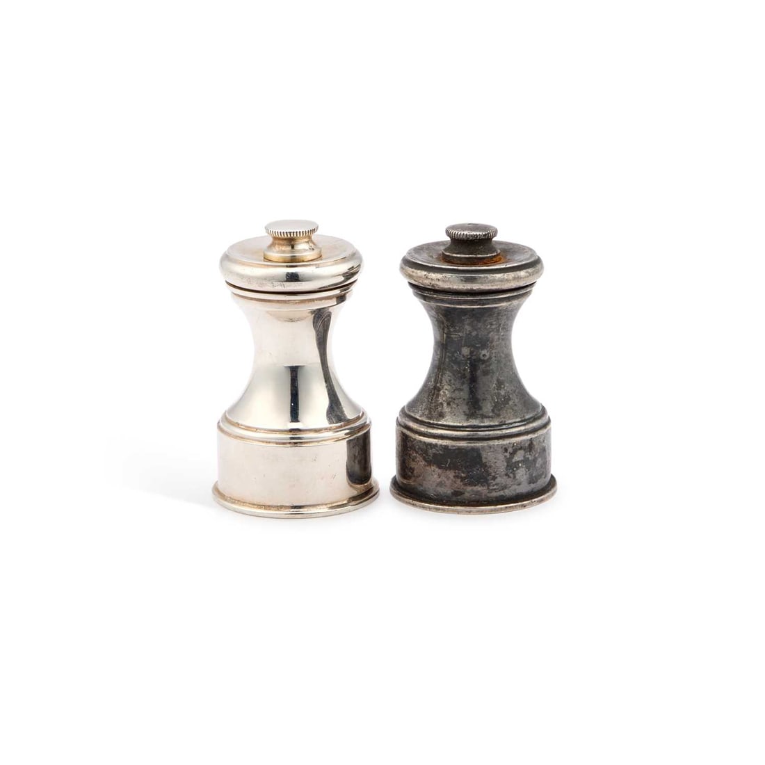 TWO SMALL ELIZABETH II SILVER PEPPER GRINDERS: TWO SMALL ELIZABETH II SILVER PEPPER GRINDERS by William Comyns & Sons Ltd (Richard Comyns), London 1975 and 1978, of conventional form. (2) Tallest 6cm