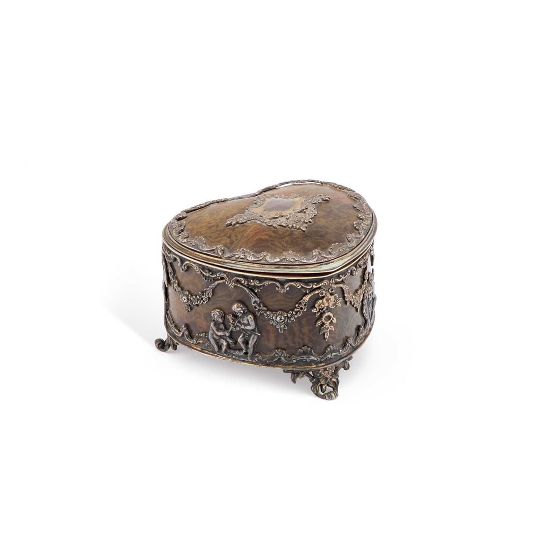 A VICTORIAN SILVER-MOUNTED TORTOISESHELL BOX: A VICTORIAN SILVER-MOUNTED TORTOISESHELL BOX by George Fox, London 1899, heart-shaped with a hinged lid and three scroll feet, the sides decorated with floral swags and putti, retailed by Jones, 41 St