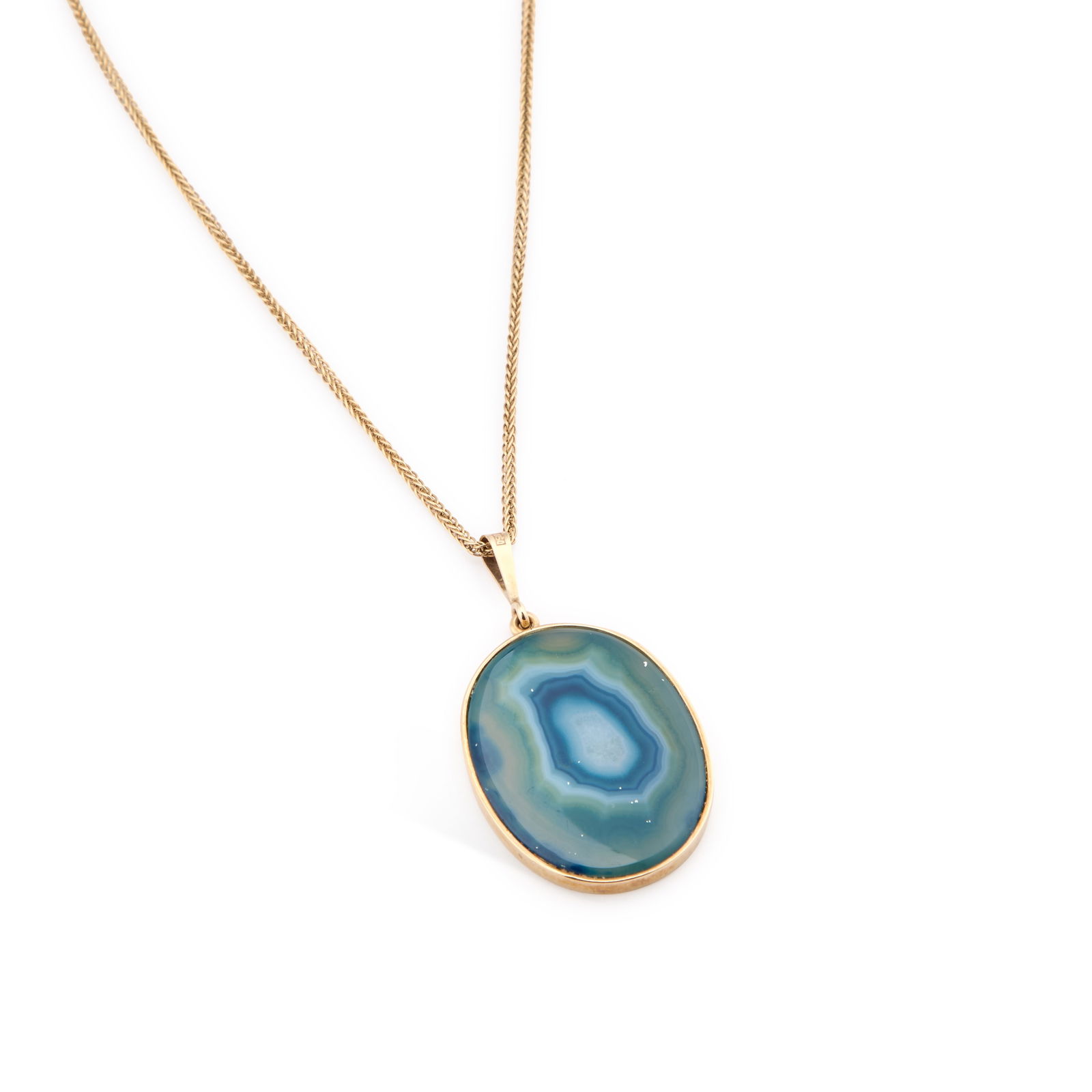 DAVID SCOTT-WALKER, A 9 CARAT GOLD DYED-BLUE AGATE PENDANT NECKLACE: DAVID SCOTT-WALKER, A 9 CARAT GOLD DYED-BLUE AGATE PENDANT NECKLACE the oval agate in a bezel setting, suspended from a prince of wales chain necklace, hallmarked Sheffield 2006. Pendant 5.3cm by 2.8c