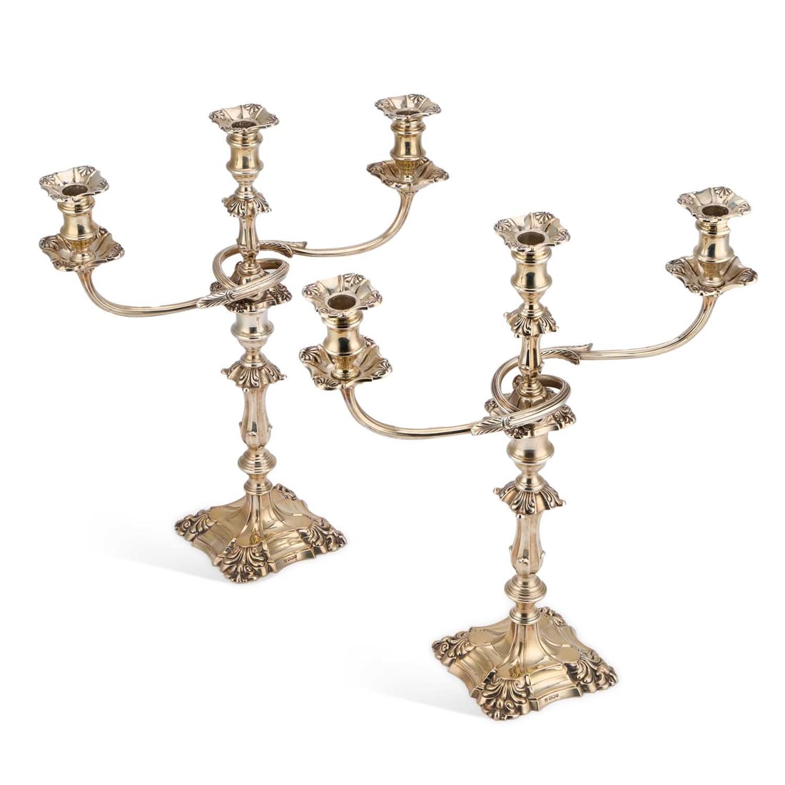 A PAIR OF GEORGE V SILVER CANDELABRA: A PAIR OF GEORGE V SILVER CANDELABRA by Thomas Bradbury & Sons Ltd, Sheffield 1935, each three-light superstructure with a pair of scroll-form leaf-capped branches, raised on a knopped stem issuin