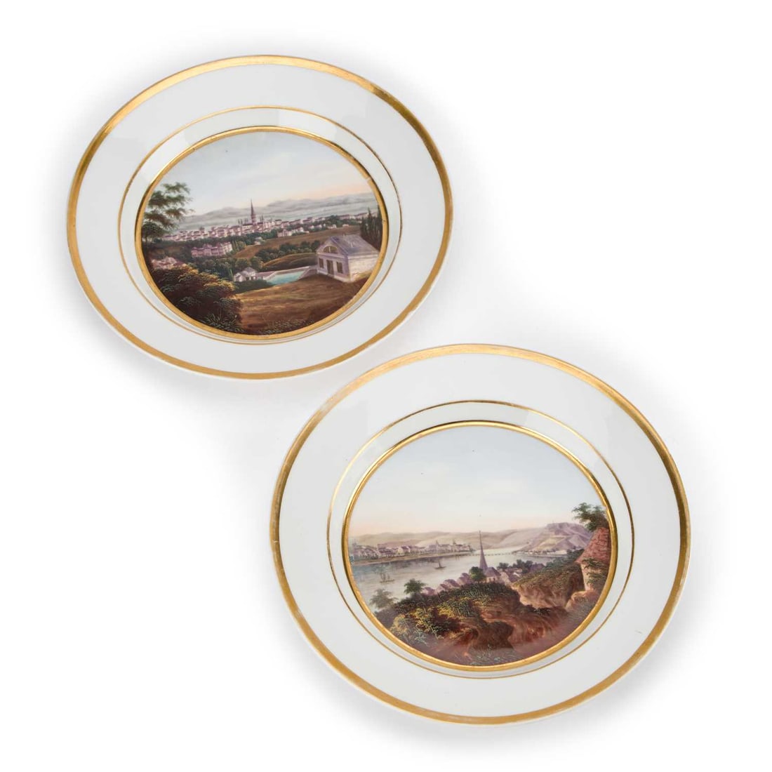 A PAIR OF BERLIN (K.P.M.) TOPOGRAPHICAL PORCELAIN PLATES CIRCA 1820-30: A PAIR OF BERLIN (K.P.M.) TOPOGRAPHICAL PORCELAIN PLATES CIRCA 1820-30 each of circular form and painted to the centre with a landscape within gilt borders, blue painted double-headed eagle and KPM ma