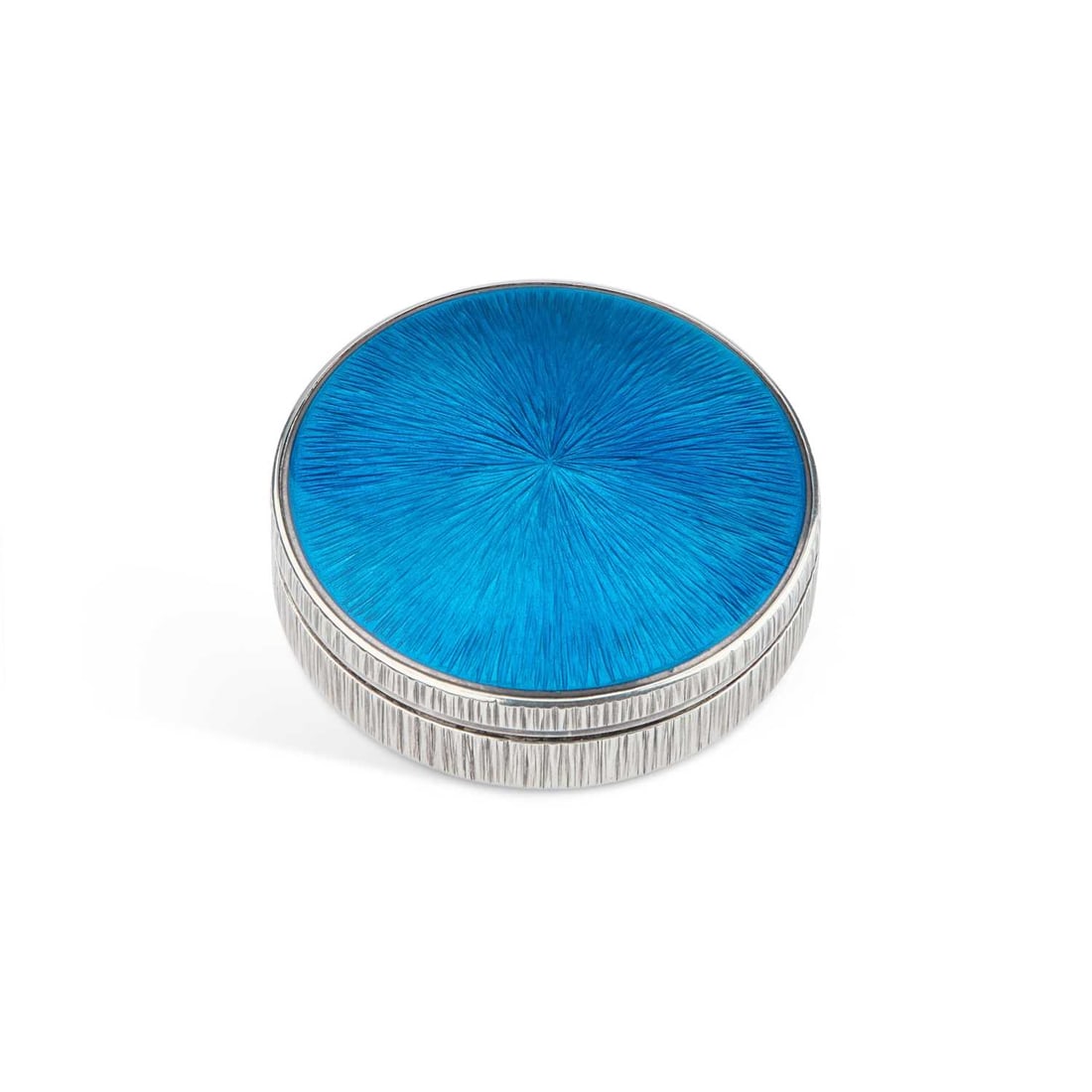 GERALD BENNEY (1930-2008) A SILVER AND ENAMEL BOX: GERALD BENNEY (1930-2008) A SILVER AND ENAMEL BOX by Gerald Benney, London 1988, circular, the pull-off cover decorated with cyan blue guilloché enamel, the sides and underside of the box are texture