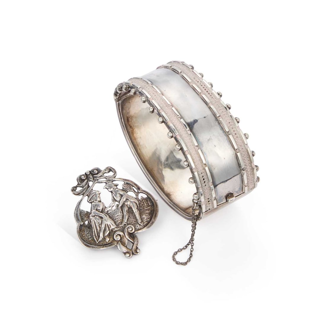 A 19TH CENTURY HINGE OPENING BANGLE AND A FIGURAL BROOCH: A 19TH CENTURY HINGE OPENING BANGLE AND A FIGURAL BROOCH the bangle with beaded decoration, the brooch depicting a courting couple, both unmarked. (2) Bangle inner diameter 17cm wide, brooch 4cm by 3.